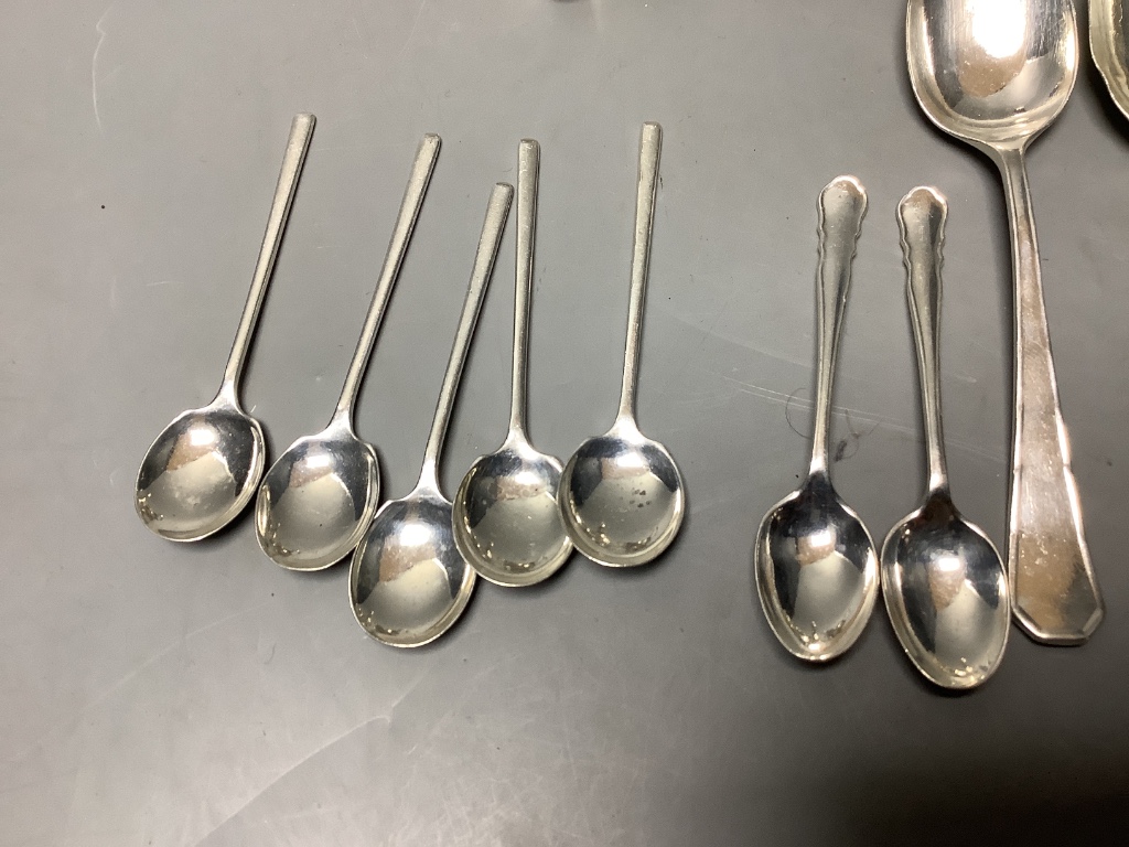 A three-piece silver condiment of oval half-reeded form, two silver sifter spoons, a pair of silver berry spoons and sundry silver flatware, approximately 18oz